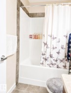 Bathtub-shower combination with tiled surround, and integrated shelf - 