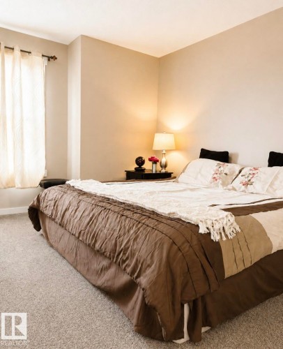 Neutral wall tones, recessed window alcove, and soft gray carpeting - 5135 1A Avenue Sw, Edmonton, AB - Indoor Photo Showing Bedroom