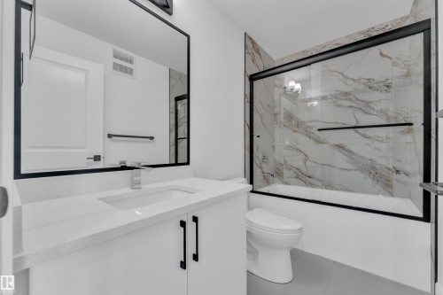 Contemporary vanity with quartz countertop and integrated sink - 82 Patriot Way, Spruce Grove, AB - Indoor Photo Showing Bathroom