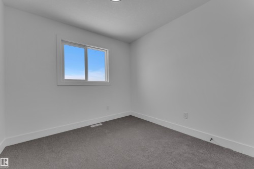 Neutral wall finishes, recessed ceiling lighting, light gray carpeting, and a white-framed window - 82 Patriot Way, Spruce Grove, AB - Indoor Photo Showing Other Room