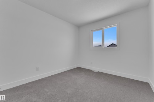 Light gray carpeting, white walls, white trim, and a double-pane window - 82 Patriot Way, Spruce Grove, AB - Indoor Photo Showing Other Room