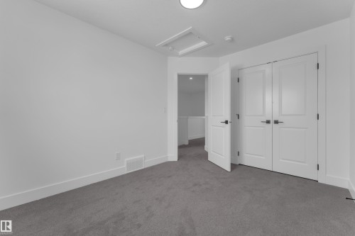 Neutral wall tones, gray carpeting, and white trim - 82 Patriot Way, Spruce Grove, AB - Indoor Photo Showing Other Room