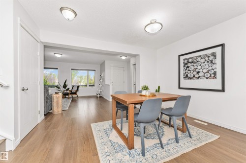 Vinyl plank flooring throughout, bright white walls, with an open, airy feel. - 4121 Tompkins Way Nw, Edmonton, AB - Indoor Photo Showing Dining Room