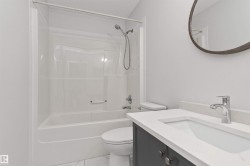 White acrylic tub and shower combination with a curved shower curtain rod - 