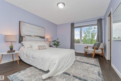Expansive window with natural light and view of the park, Vinyl plank flooring and large walk in closet - 4121 Tompkins Way Nw, Edmonton, AB - Indoor Photo Showing Bedroom