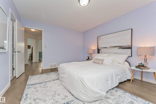 Vinyl plank flooring throughout, complemented by light-toned wall paint and white trim - 4121 Tompkins Way Nw, Edmonton, AB - Indoor Photo Showing Bedroom