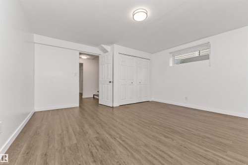 Wood-finish flooring throughout, white walls, and a recessed window - 4121 Tompkins Way Nw, Edmonton, AB - Indoor Photo Showing Other Room