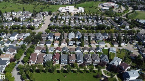 Residential neighborhood with varied rooflines, paved streets, and mature trees - 4121 Tompkins Way Nw, Edmonton, AB - Outdoor With View