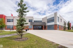 Multi-story commercial building featuring red and cream-colored paneling - 