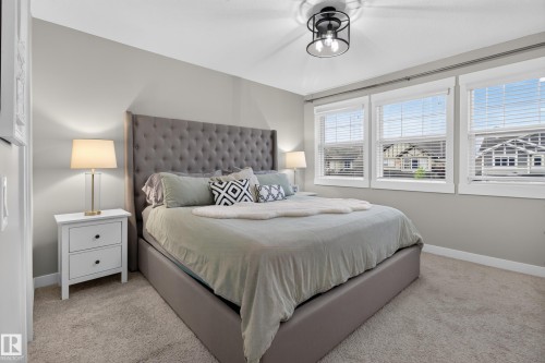 Neutral-toned bedroom featuring wall-to-wall carpeting and light gray walls - 17305 73 Street Nw, Edmonton, AB - Indoor Photo Showing Bedroom