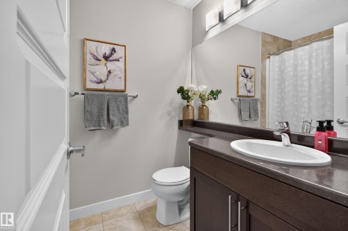 Full bathroom featuring a dark wood-finish vanity with an integrated sink and chrome fixtures - 17305 73 Street Nw, Edmonton, AB - Indoor Photo Showing Bathroom