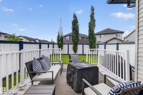 Deck with white railing and privacy fencing enclosing a grass lawn with mature trees - 17305 73 Street Nw, Edmonton, AB - Outdoor With Deck Patio Veranda With Exterior