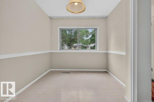 Neutral-toned walls with chair rail molding and white trim - 9026 92 Street Nw, Edmonton, AB - Indoor Photo Showing Other Room