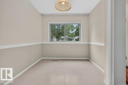 Neutral-toned walls with chair rail molding and white trim - 