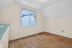 Hardwood flooring, painted walls, window with natural lighting, textured ceiling, built-in cabinetry with a blue counter - 