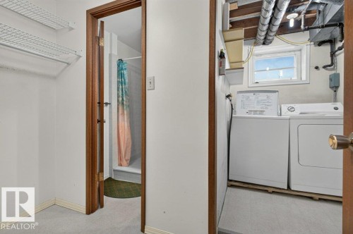 Laundry area featuring a window and exposed ceiling utilities - 9026 92 Street Nw, Edmonton, AB - Indoor Photo Showing Laundry Room