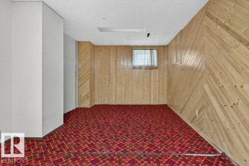 Wood paneling walls, recessed window, patterned carpet flooring, drop ceiling - 9026 92 Street Nw, Edmonton, AB - Indoor Photo Showing Other Room