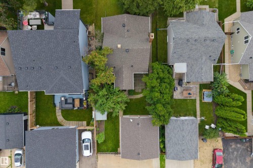 Residential property featuring a shingle roof and a spacious backyard with a deck - 9026 92 Street Nw, Edmonton, AB - Outdoor