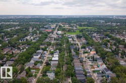 Aerial perspective of a residential neighborhood with tree-lined streets and varied architectural styles - 