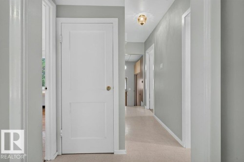 Hallway with light gray walls, white trim, and a flush mount ceiling fixture - 9026 92 Street Nw, Edmonton, AB - Indoor Photo Showing Other Room