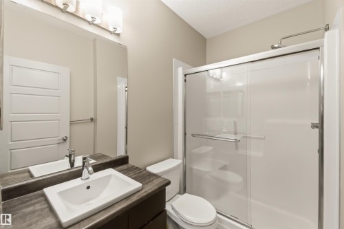 Integrated vanity with a rectangular basin sink, chrome faucet, and storage cabinetry - #414 5510 Schonsee Dr Nw, Edmonton, AB - Indoor Photo Showing Bathroom
