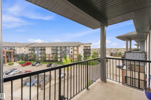 Private balcony with concrete flooring, black metal railings, and a solid overhead covering - #414 5510 Schonsee Dr Nw, Edmonton, AB - Outdoor With Exterior