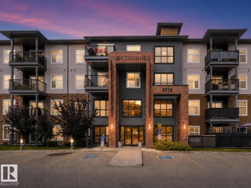 Contemporary multi-story building with a brick facade accent and multiple private balconies - #414 5510 Schonsee Dr Nw, Edmonton, AB - Outdoor With Facade