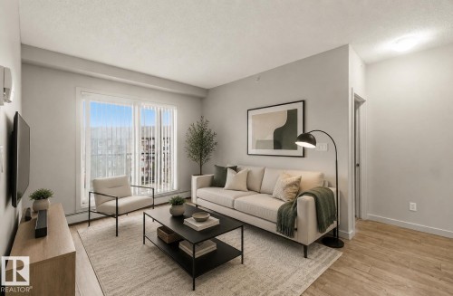 Recessed lighting, wood-finish flooring, and a large window with vertical blinds - #414 5510 Schonsee Dr Nw, Edmonton, AB - Indoor Photo Showing Living Room