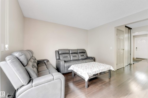 Wood-finish flooring throughout - #37 1411 Mill Woods Rd E Nw, Edmonton, AB - Indoor Photo Showing Living Room
