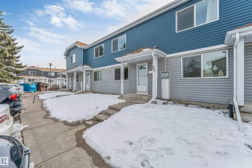 Two-story exterior with horizontal siding, covered entry, and concrete walkway - #37 1411 Mill Woods Rd E Nw, Edmonton, AB - Outdoor