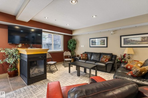 #233 279 Suder Greens Dr Nw, Edmonton, AB - Indoor Photo Showing Living Room With Fireplace