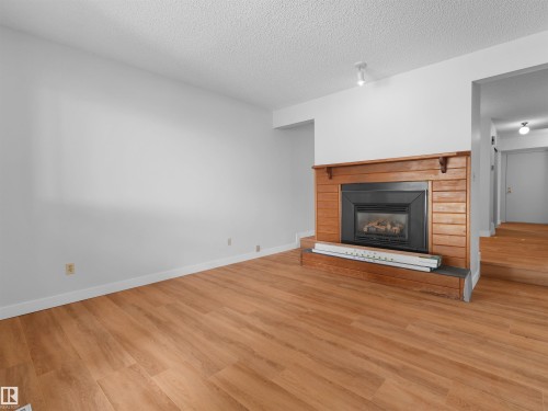 #50 1904 48 St Nw, Edmonton, AB - Indoor Photo Showing Living Room With Fireplace