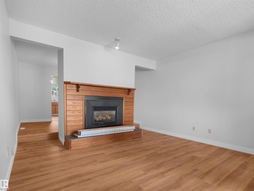 #50 1904 48 St Nw, Edmonton, AB - Indoor Photo Showing Living Room With Fireplace