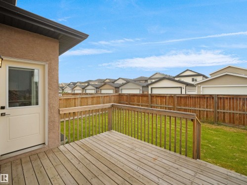 Private backyard featuring a wood deck, wood privacy fencing, and a manicured lawn - 17020 62 Street Nw, Edmonton, AB - Outdoor With Exterior