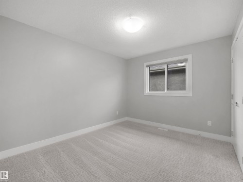 Neutral-toned wall finish, wall-to-wall carpeting, and a flush mount ceiling light fixture - 17020 62 Street Nw, Edmonton, AB - Indoor Photo Showing Other Room