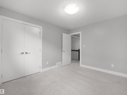 Light gray carpeting, neutral wall paint, white trim, and a flush mount ceiling light fixture - 17020 62 Street Nw, Edmonton, AB - Indoor Photo Showing Other Room