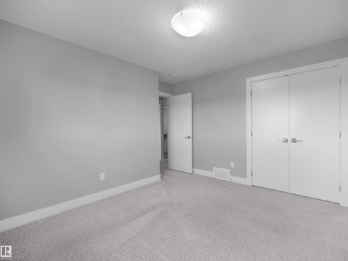 Recessed ceiling light fixture, neutral carpet flooring, white trim, and white interior doors - 17020 62 Street Nw, Edmonton, AB - Indoor Photo Showing Other Room
