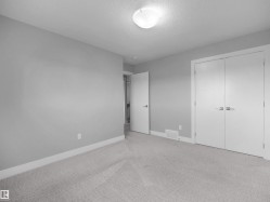 Recessed ceiling light fixture, neutral carpet flooring, white trim, and white interior doors - 