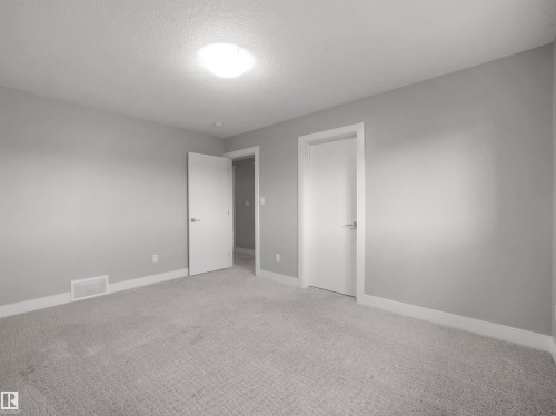 Plush carpeting, light gray wall paint, and white trim - 17020 62 Street Nw, Edmonton, AB - Indoor Photo Showing Other Room