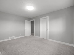 Plush carpeting, light gray wall paint, and white trim - 