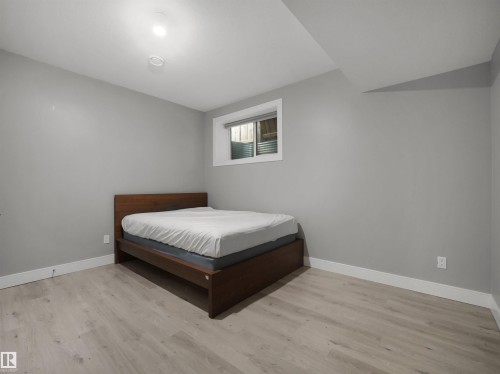 Recessed ceiling lighting, light wood-finish flooring, and a window with blinds - 17020 62 Street Nw, Edmonton, AB - Indoor Photo Showing Bedroom