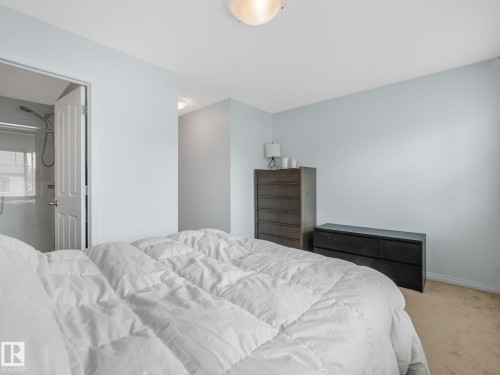 Bedroom featuring light blue walls and neutral carpeting - #21 1140 Chappelle Bv Sw, Edmonton, AB - Indoor Photo Showing Bedroom