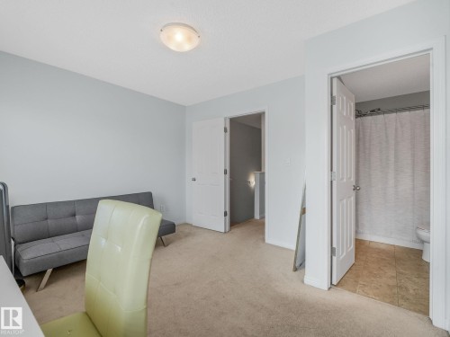 Carpeted room featuring light-colored walls and a flush-mount ceiling light fixture - #21 1140 Chappelle Bv Sw, Edmonton, AB - Indoor Photo Showing Other Room