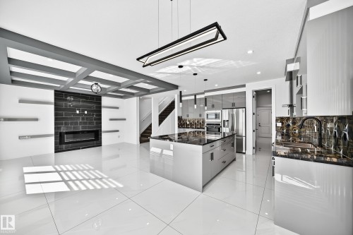Open-concept living space with large format tile flooring and a coffered ceiling - 3101 Soleil Boulevard, Beaumont, AB - Indoor