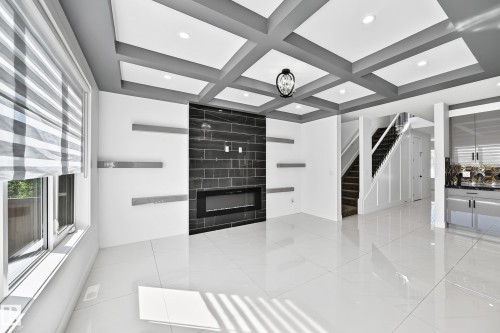 Coffered ceiling with recessed lighting and a central chandelier - 3101 Soleil Boulevard, Beaumont, AB -  Photo Showing Other Room