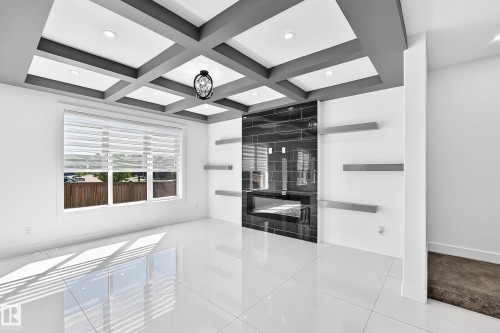 Coffered ceiling with recessed lighting and a central chandelier - 3101 Soleil Boulevard, Beaumont, AB - Indoor Photo Showing Other Room