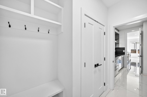 Built-in entryway storage with shelving and coat hooks - 3101 Soleil Boulevard, Beaumont, AB - Indoor Photo Showing Other Room