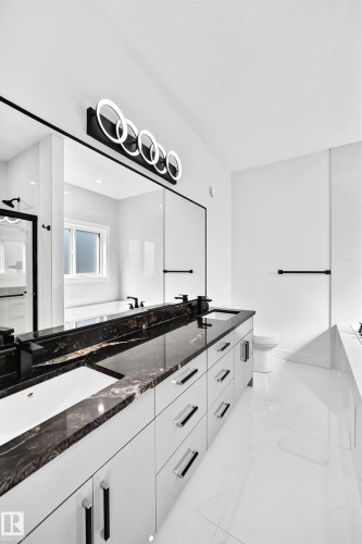 Dual vanity with dark patterned countertops and integrated sinks - 3101 Soleil Boulevard, Beaumont, AB - Indoor