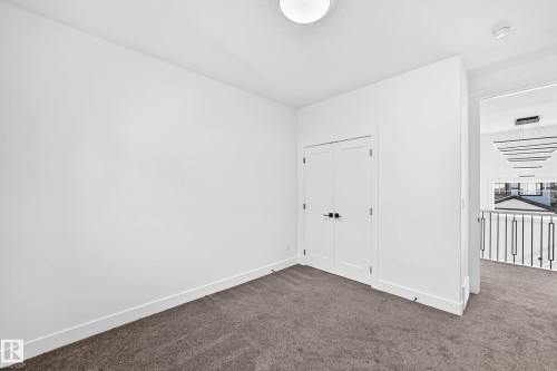 Neutral wall tones, gray carpeting, and a flush-mount ceiling light - 3101 Soleil Boulevard, Beaumont, AB - Indoor Photo Showing Other Room