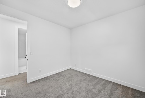 Recessed ceiling light fixture and grey carpet flooring - 3101 Soleil Boulevard, Beaumont, AB - Indoor Photo Showing Other Room
